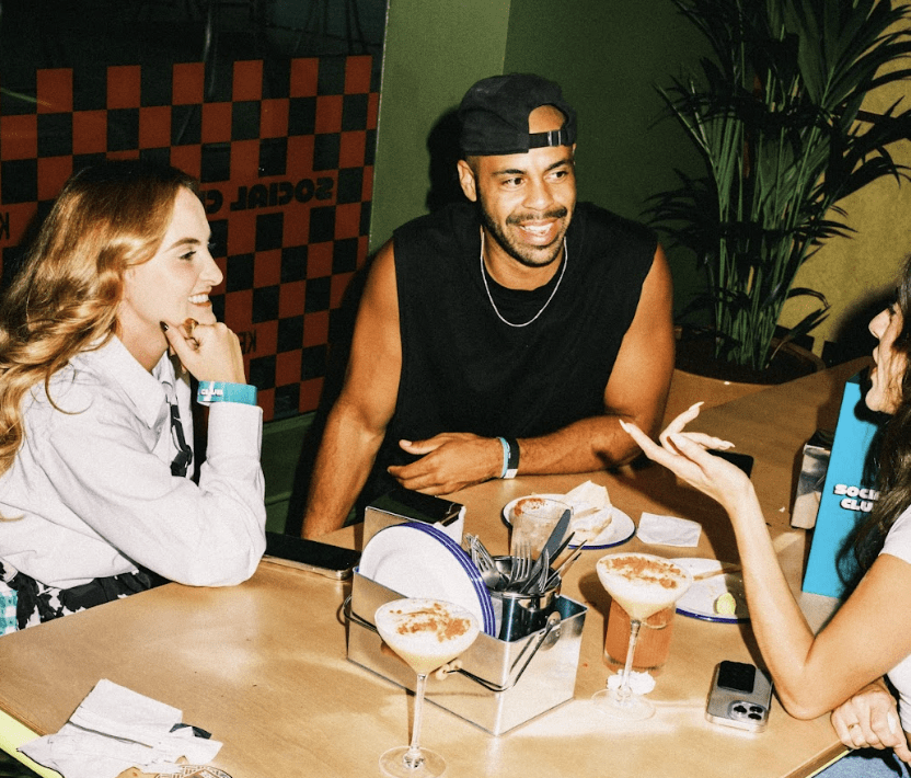 KERB social club people sat at table